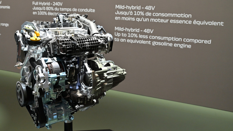 An engine sitting on a display stand with a mild hybrid system.