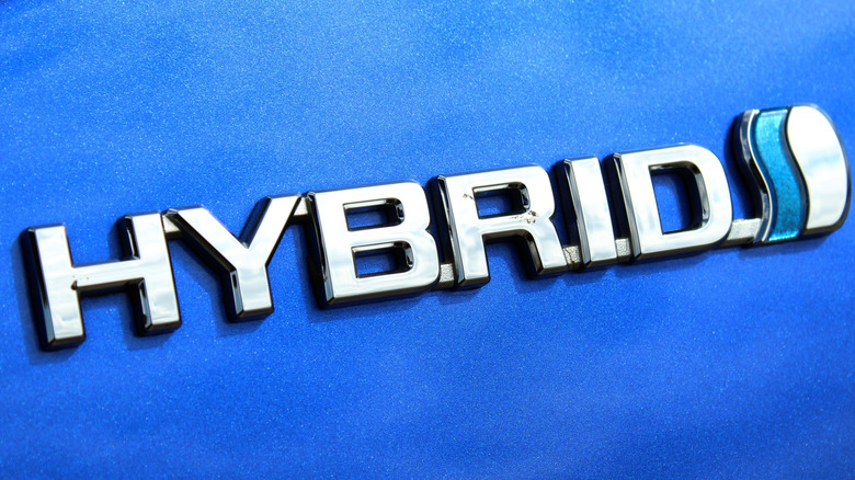 A blue car with a Hybrid badge on it.