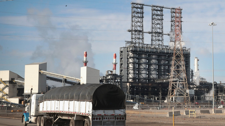 A covered truck drives past the stacks of the BP Whiting refinery plant in Indiana.