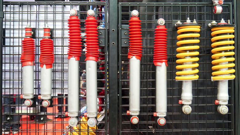 A set of dampers and struts hanging at a garage wall