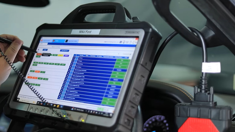 A technician using Ford's dealer-level diagnostic systems