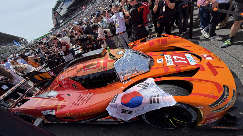 An orange Genesis Magma Racing Le Mans car on the grid