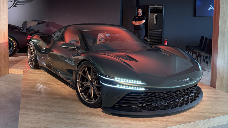 Front 3/4 view of the green Genesis Magma GT concept on a wooden stage