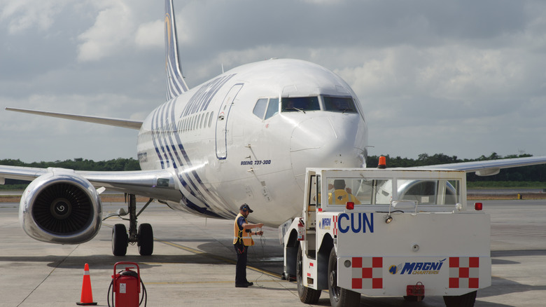 A Boeing 737 operated by Magnicharters on an airport's tarmac
