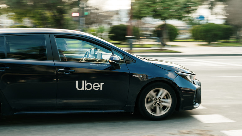 Seville, Spain - 23 January, 2025: A Uber ride-sharing car in motion in Seville, Spain