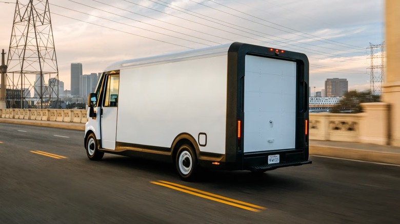 2025 Chevy BrightDrop van driving over a bridge in a city