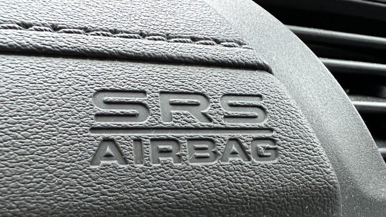 The SRS airbag label on the dashboard of a modern car