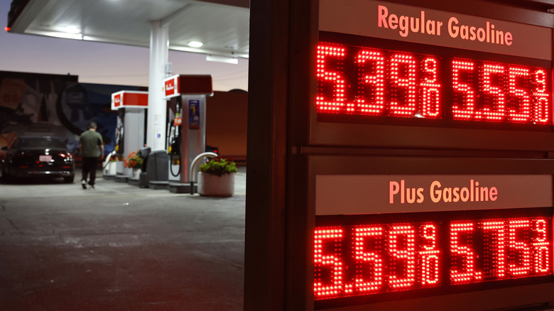 A customer walks near gas prices displayed at a Shell gas station on July 7, 2026 in Pasadena, California.