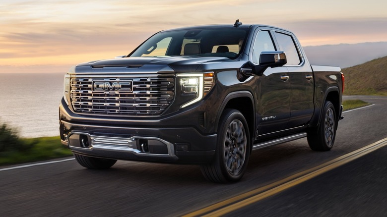 2026 GMC Sierra Denali Ultimate 1500 Crew Cab driving along the coast.