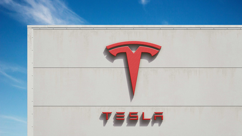 Delhi, India- 20 May 2025; Tesla Inc. corporate building featuring bold 3D red Tesla logo under bright blue sky, symbolizing innovation and electric vehicle dominance in the global stock market