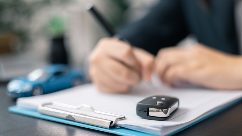 Dealership offered various finance options, including an auto loan or lease, making it easier to buy or rent a car from the company. Agent reviewed contract, finalizing insurance agreement.