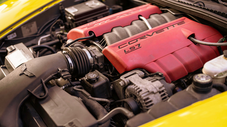 A close-up of a GM's LS7 engine in a yellow Corvette engine bay.
