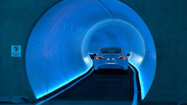 LAS VEGAS, NEVADA - APRIL 09: A Tesla car drives through a tunnel in the Central Station during a media preview of the Las Vegas Convention Center Loop on April 9, 2021 in Las Vegas, Nevada.