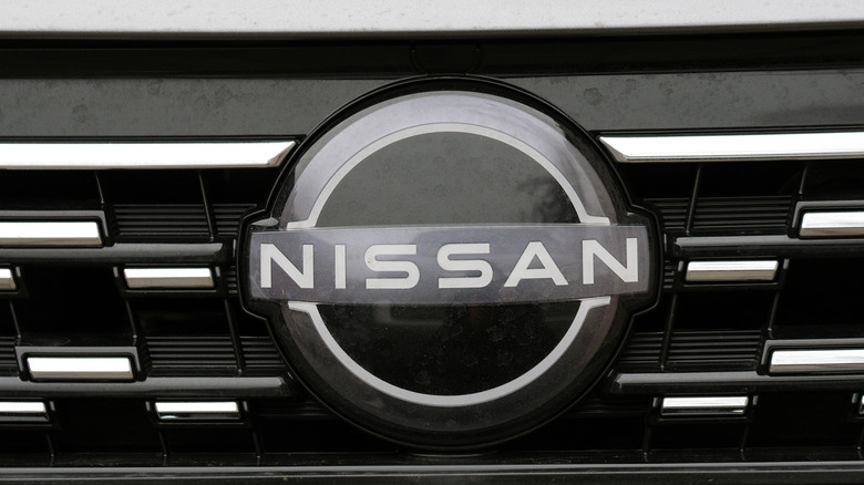 Minsk, Belarus. Nov 6, 2024. New Nissan badge on front grille of electric car Nissan Sylphy. Nissan new redisigned emblem. Nissan logo close-up