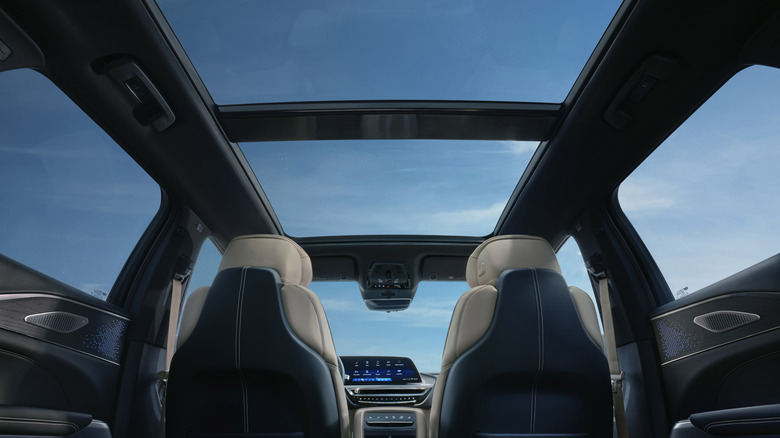 A photo looking up from the rear seat showing the glass roof option showing a blue sky