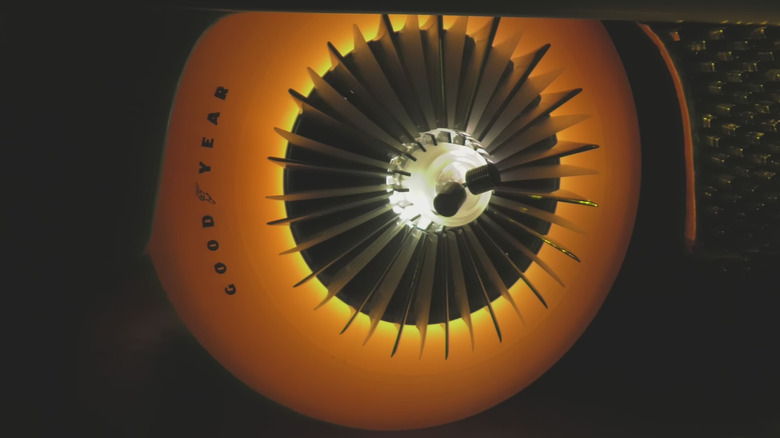 A close-up of one of Goodyear's glowing tires housing a turbine-like wheel.