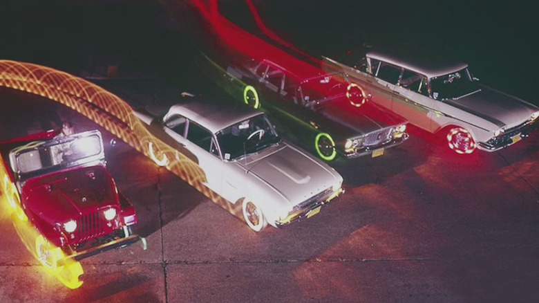 A stylized advertisement featuring four cars fitted with Goodyear's glowing tires.