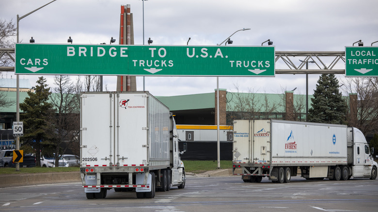 Trucks make their way to the Ambassador Bridge to cross into the United States at Detroit on April 1, 2025 in Windsor, Canada.