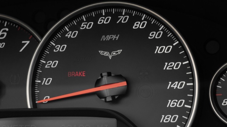 An up-close image of a car's speedometer showing the needle at 0 mph
