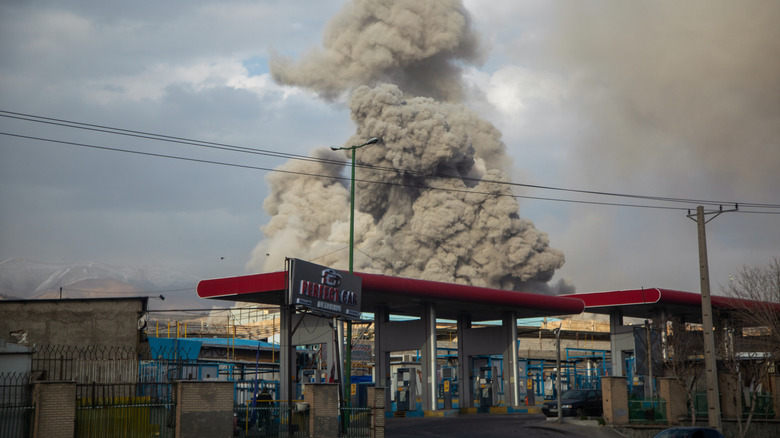 A plume of smoke rises in Tehran, Iran