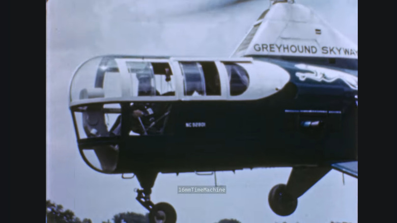 Greyhound's helicopter bus as part of its Greyhound Skyways taking flight. It looks like what you would expect a combined helicopter and bus would look like.