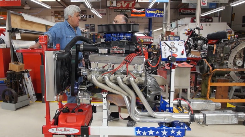 Jay Leno with an engine on a test stand