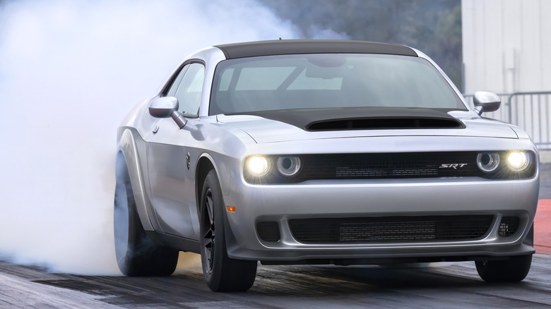 A silver 2023 Dodge Challenger SRT Demon 170 burning rubber