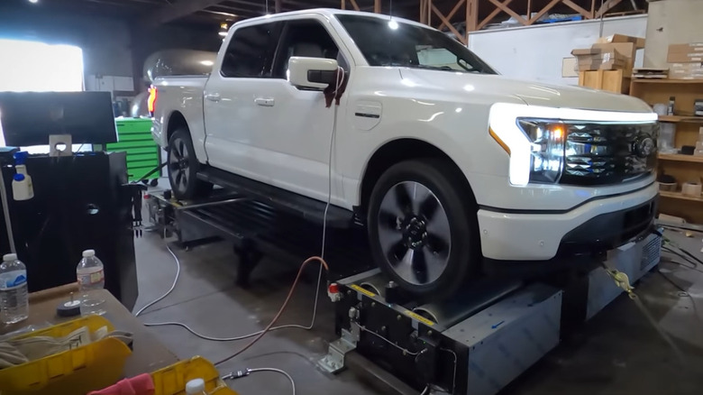 A white 2022 Ford F-150 Lightning EV on a dyno