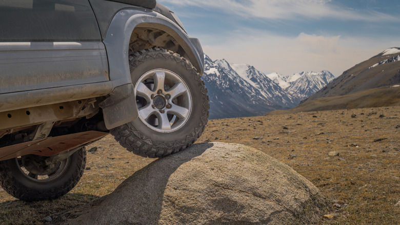 SUV off-road climbing a rock