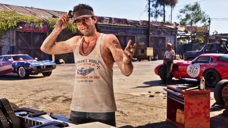 A mechanic character standing in front of cars in Grand Theft Auto VI