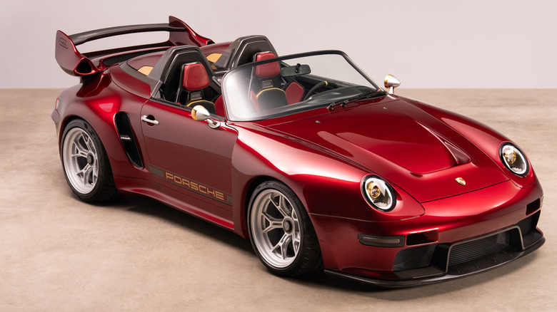 A front three-quarters shot of the candy apple red Project Endgame parked on a light-colored floor in front of a blank beige background