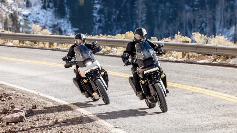 Two bikers riding down a highway on Harley-Davidson Pan America 1250s