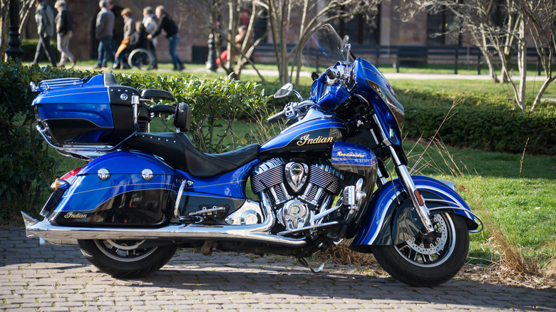 Profile view of blue Indian custom motorbike parked in the street