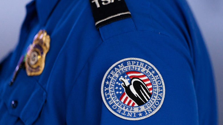 A Transportation Security Administration (TSA) patch on an employee's shirt at Orlando International Airport.