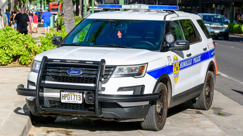 A white SUV of the Hawaii Sheriff Division parked on the side of the street.