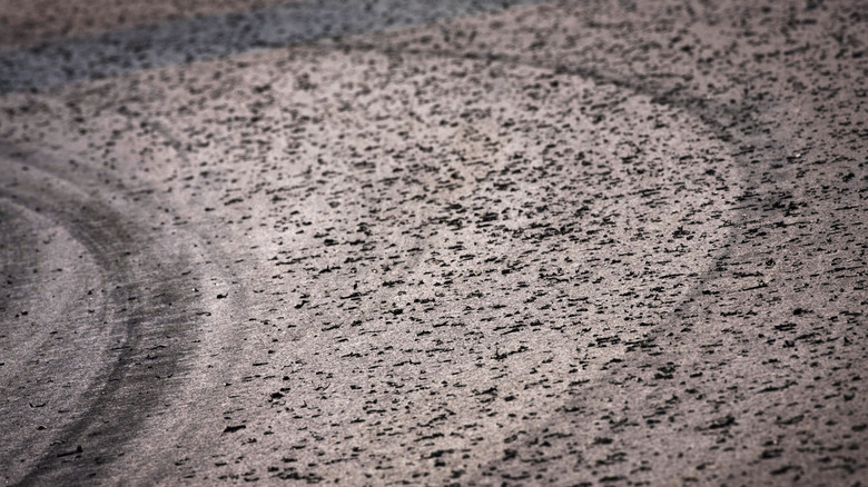 A motorsports track covered with tire marbles