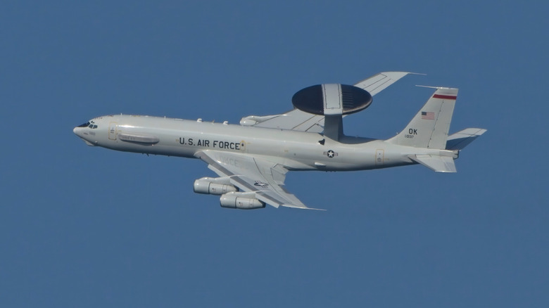An E-3 Sentry AWACS flying against a blue sky