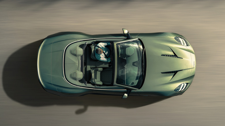 An Aston Martin Vanquish Volante convertible seen from above with its top down