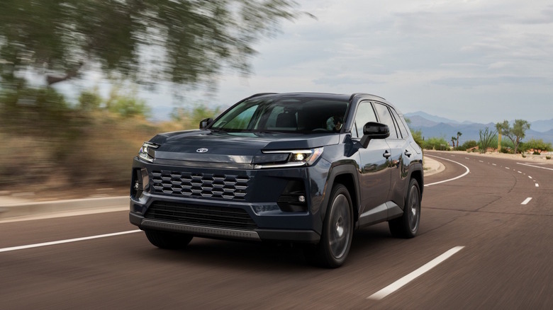 A black 2026 Toyota RAV4 on a roadway.