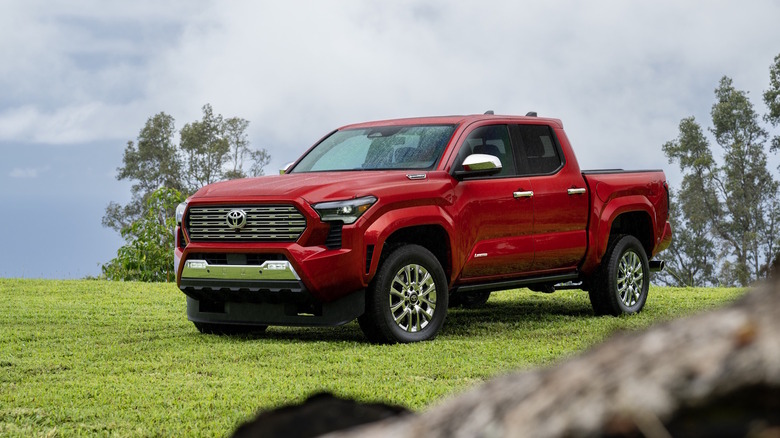 A red 2026 Toyota Tacoma on a hill.