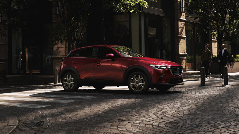 A red 2020 Mazda CX-3 in front of a building.
