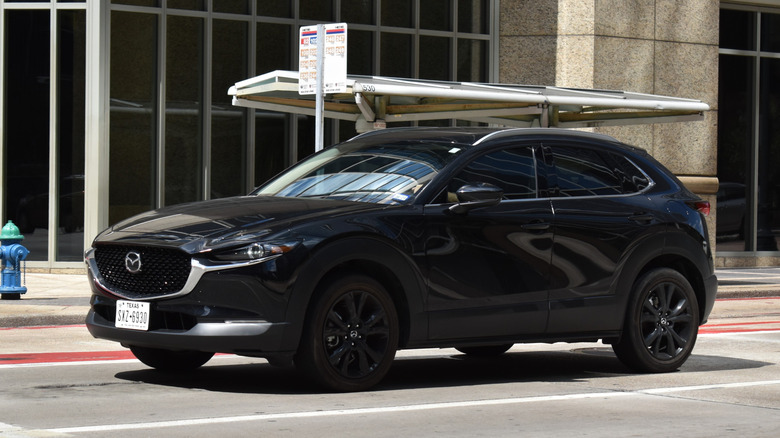 A black Mazda CX-5 on a city street.