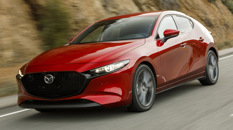 Fourth-gen Mazda3 Hatchback driving down a winding road