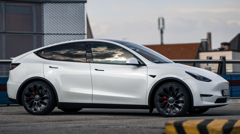A white Tesla Model Y in a parking lot.