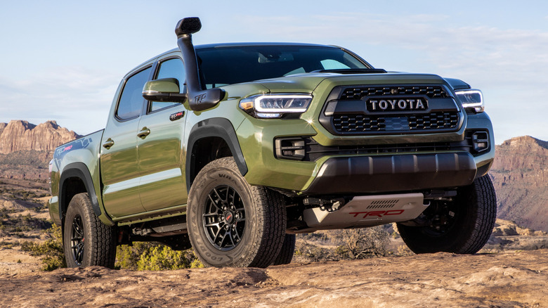 A green 2020 Toyota Tacoma TRD Pro parked on rocky off-road terrain