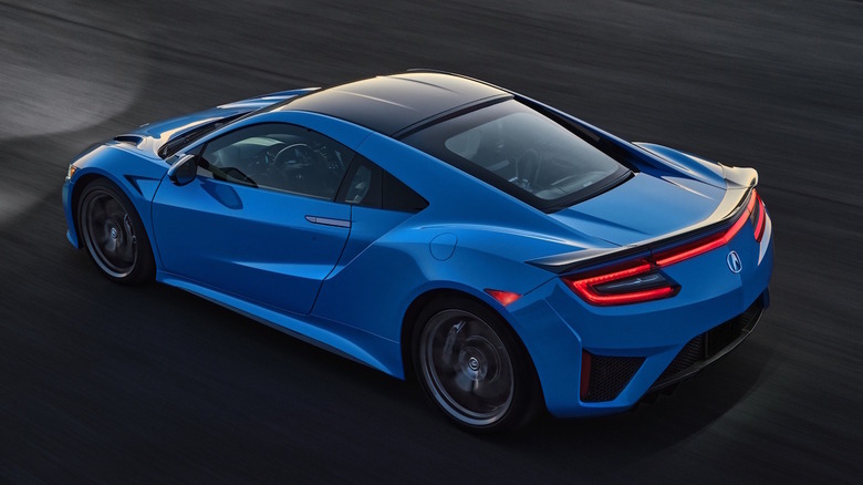 A blue 2021 Acura NSX being driven at night.