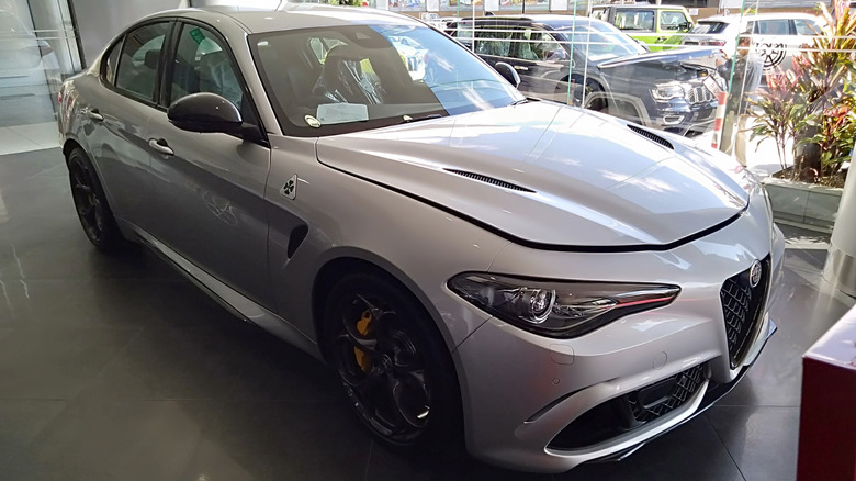 The 2021 Alfa Romeo Giulia Quadrifoglio parked indoors with other cars parked in the outside environment