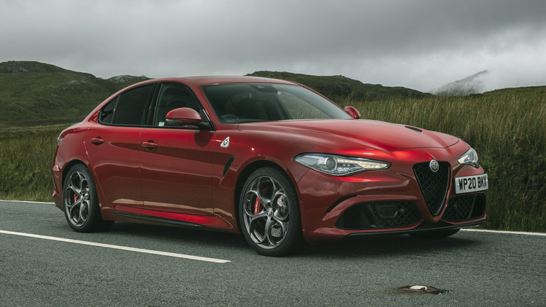A front-right static shot of a red Alfa Romeo Giulia Quadrifoglio