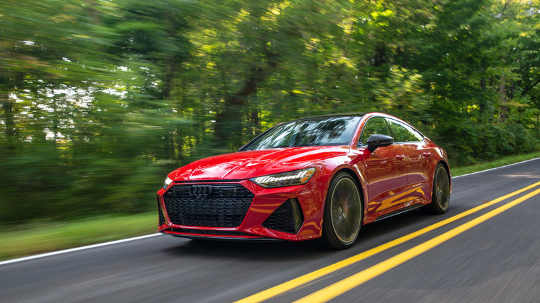 Dynamic driving shot of a Tango Red 2021 Audi RS 7