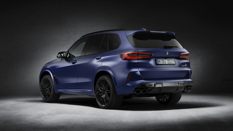 The rear 3/4 of a 2021 BMW X5 Competition against a dark background